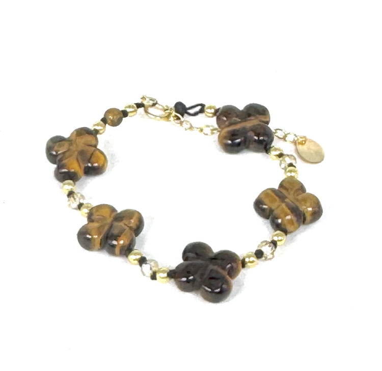 La simplicité fun du lien, la force du trèfle à quatre feuilles.

Bracelet sur cordon -&nbsp; Trèfles en œil de tigre - Perles d'onyx et en or laminé 14 carats.