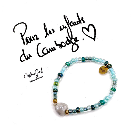 Capsule humanitaire pour les enfants du Cambodge.
Bracelet élastique pour les grandes et les petites - Perle cœur en céramique gris - Perles de rocaille.